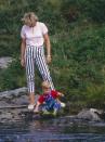 <p>The Princess of Wales and Prince Harry play by the River Dee during a summer vacation to Balmoral Castle in Scotland. The castle is where she spent one of her first dates with Prince Charles (and the entire royal family).</p>