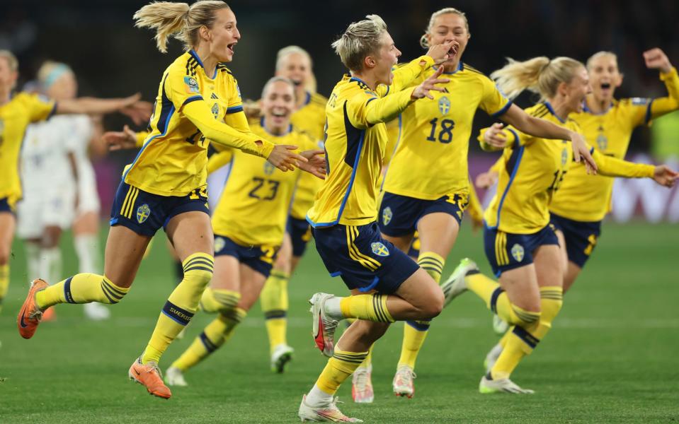 Lina Hurtig of Sweden celebrates with team-mates after scoring her sides winning penalty