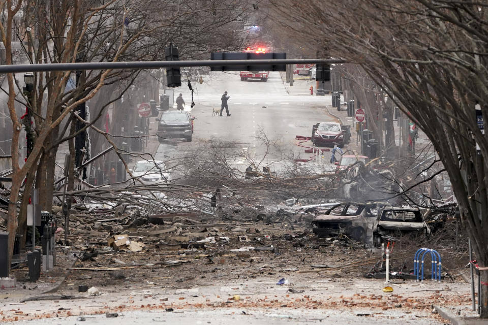 Emergency personnel work near the scene of an explosion in downtown Nashville, Tenn., Friday, Dec. 25, 2020. Buildings shook in the immediate area and beyond after a loud boom was heard early Christmas morning.(AP Photo/Mark Humphrey)