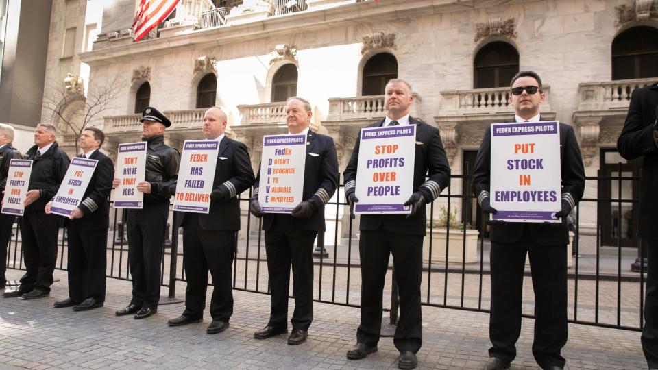 Pilots in front of the New York Stock Exchange spread the message to investors that FedEx's performance hinges on keeping good pilots. (Photo: Air Line Pilots Association)