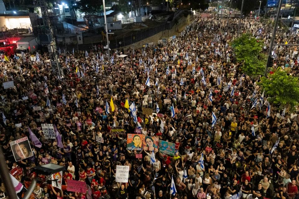 Protesters hold signs and flags during a demonstration calling for an hostages deal and against the Israeli Prime Minister Benjamin Netanyahu and his government in Tel Aviv (Getty Images)