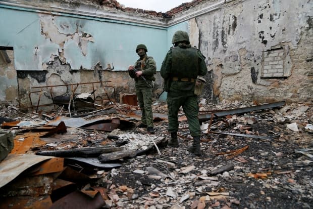 Militants of the self-proclaimed Luhansk People's Republic (LNR) are seen at fighting positions on the line of separation from the Ukrainian armed forces on Tuesday.