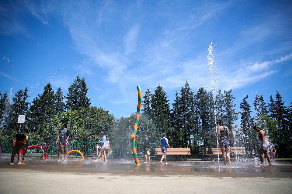 Kids play in the splash pad at River Road Park. City staff said splash pads could be closed as part of budget cuts.