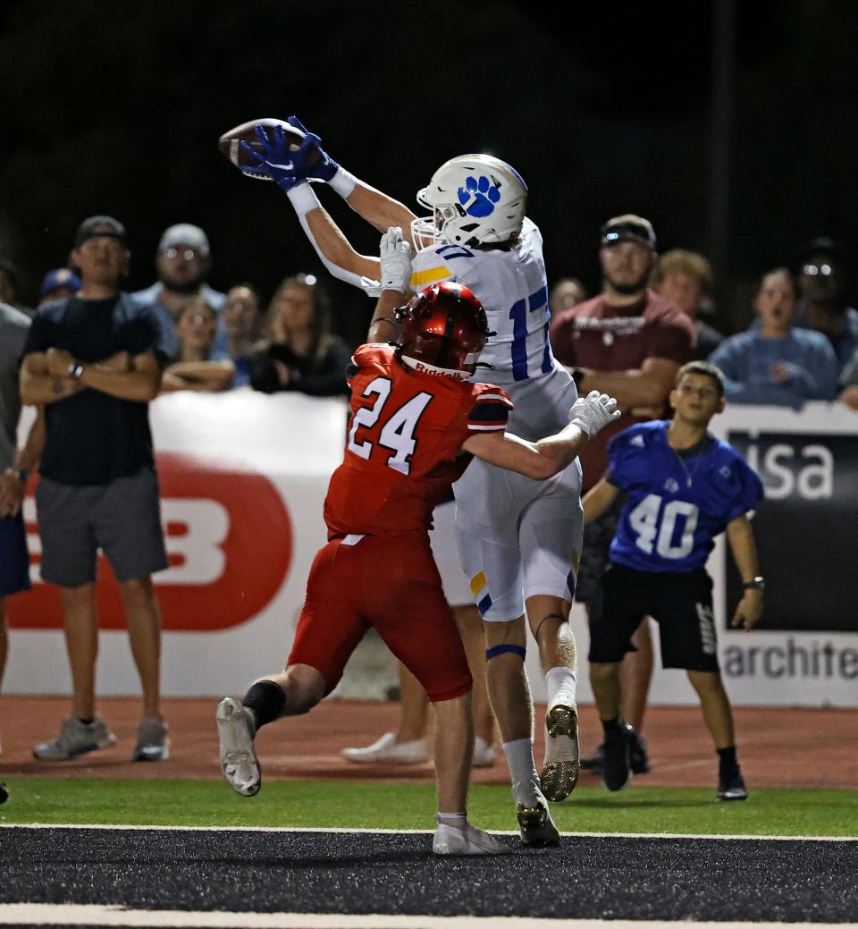 Frenship's Leyton Stone (17) catches a touchdown around Lubbock-Cooper's Carson Bradshaw (24) during a football game, Friday, Sept. 2, 2022, at Pirate Stadium at First United Park. 
