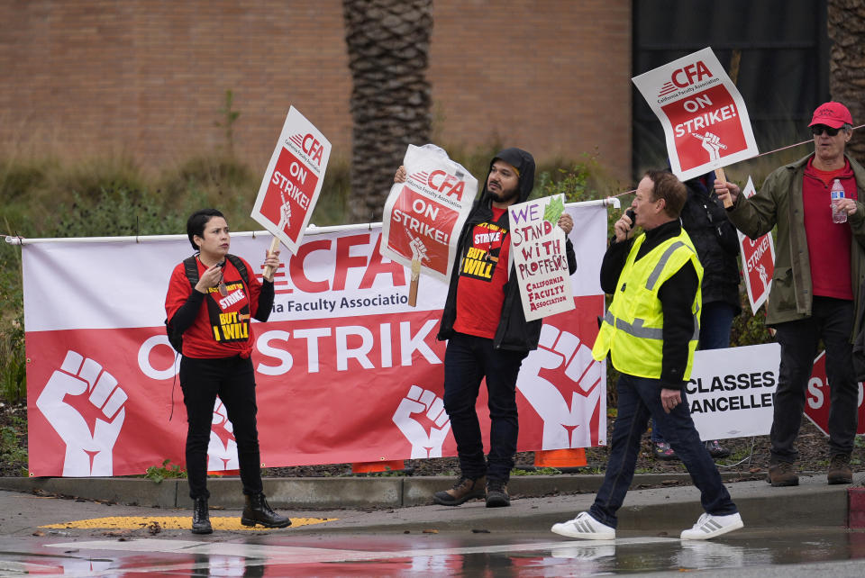 Demonstrators picked and shout slogans outside the Cal State Northridge campus Sunday, Jan. 21, 2024, in Northridge, Calif. More than 30,000 professors, librarians, plumbers, electricians, and other workers at California State University, the largest public university system in the U.S., have started a weeklong strike on Monday to demand higher wages. (AP Photo/Marcio Jose Sanchez)