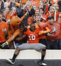 Oklahoma State safety Marelle Martin, center, celebrates with fans following a 59-24 victory over Baylor in an NCAA college football game in Stillwater, Okla., Saturday, Oct. 29, 2011. (AP Photo/Sue Ogrocki)