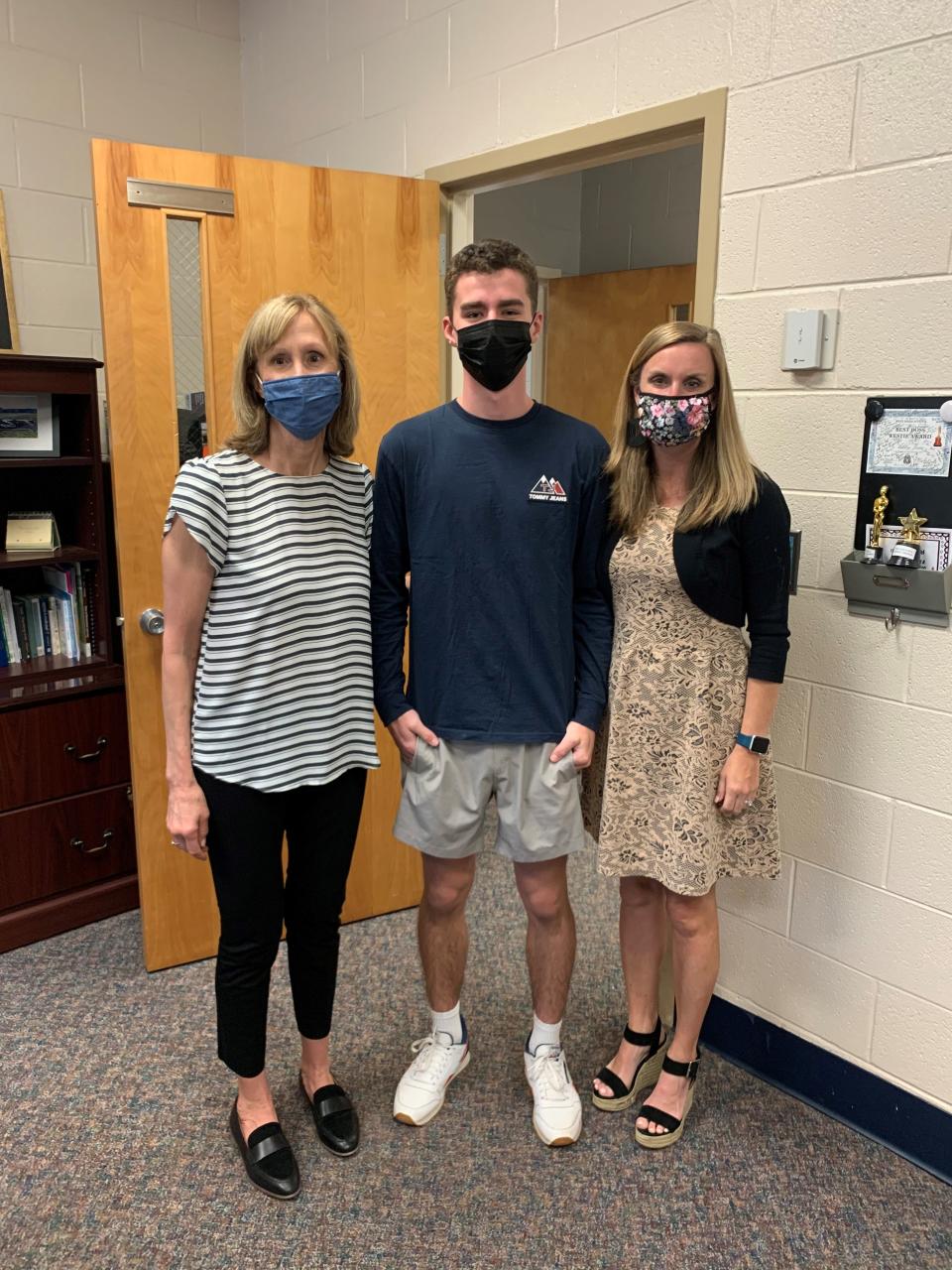 Josh Stevens is congratulated by college and career counselor Sarah Bast, left, and principal Dr. Ashley Speas for being named valedictorian at West High this year.