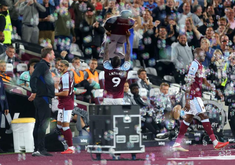 West Ham United’s Michail Antonio celebrates scoring his side’s third goal against Leicester by raising a cardboard cutout of himself. The Hammers won 4-1.