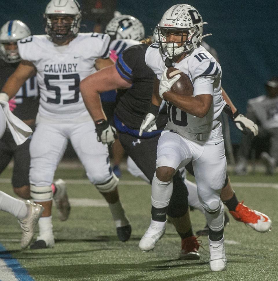 Calvary Christian School running back Sean Cuono (10) rushes the ball against Lakeland Christian School during the first half at Lakeland Christian School in Lakeland Friday night. October 21, 2022.