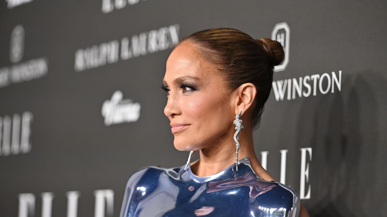  JLo's slicked-back bun and dangle statement earrings were the perfect combination as the A-lister made a statement on the red carpet. 