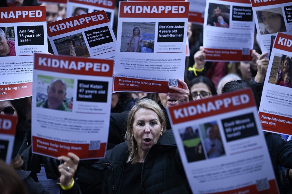 Protesters in London on Saturday with posters of some of the estimated 230 people being held hostage by Hamas (AFP via Getty Images)