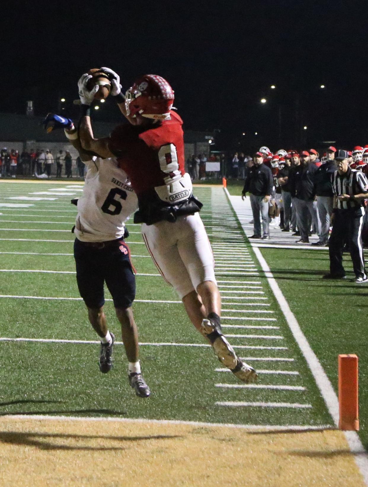 Savannah Christian's David Bucey hauls in a touchdown catch over Sandy Creek's Cameron Watts  during Friday's game at Pooler Stadium.