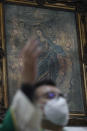 Father Adrian Israel Vazquez Velazquez Mass in a provisional chapel adjacent to Nuestra Senora de Los Angeles, or Our Lady of Angels church, which is in the early stages of reconstruction three years after an earthquake collapsed almost half of its 18th-century cupola in Mexico City, Sunday, Oct. 4, 2020. To date, about 1,100 of the 2,340 damaged structures have been restored. (AP Photo/Rebecca Blackwell)