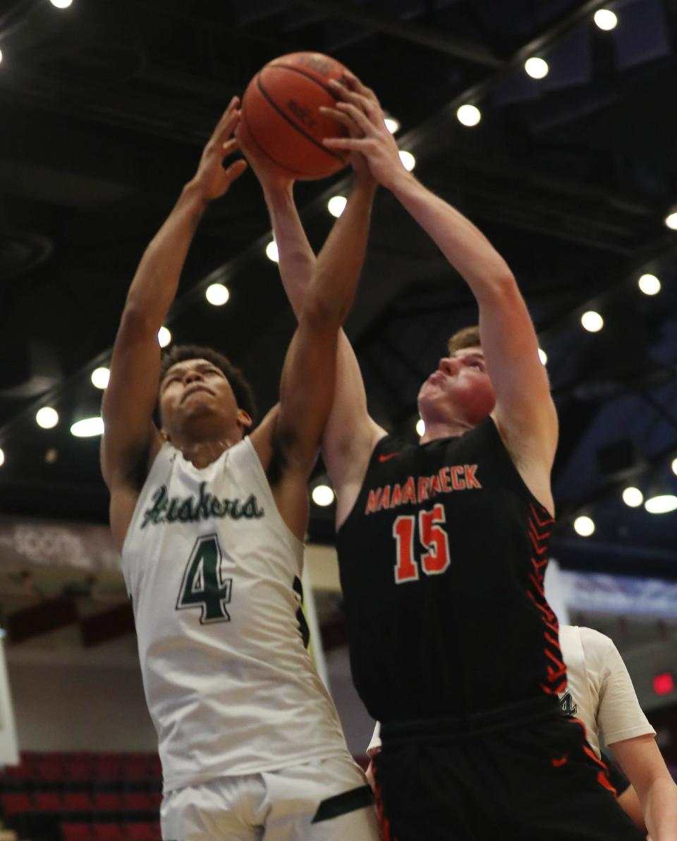 Yorktown's Brandon Montero (4) and Mamaroneck's Will Plunkett (15) battle for a rebound during the Slam Dunk Classic at the Westchester County Center in White Plains Jan. 5, 2024.