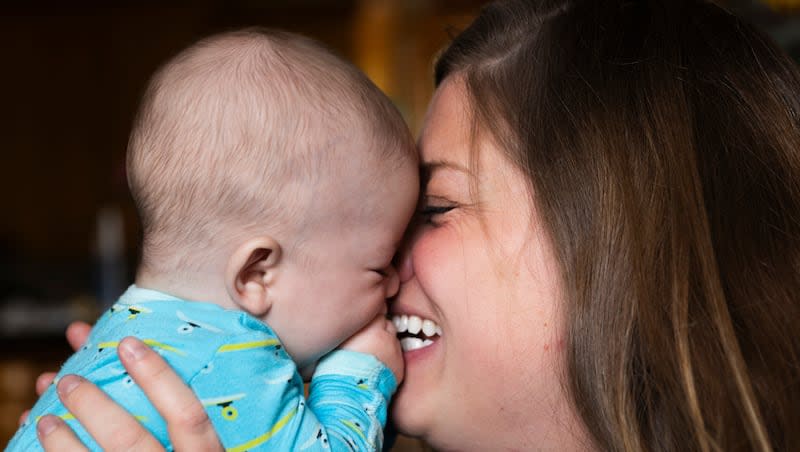 Four-month-old Edoardo Atzeni is kissed by his mother Nicole at their home in Salt Lake City, on Wednesday May 8, 2024.