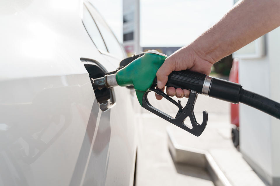 A person pumping gas