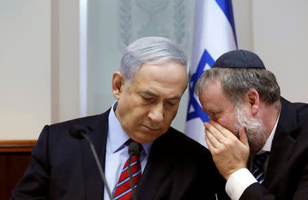 Israel's Prime Minister Benjamin Netanyahu listens to Cabinet Secretary Avichai Mandelblit during the weekly cabinet meeting in Jerusalem November 16, 2014. REUTERS/Gali Tibbon/Pool