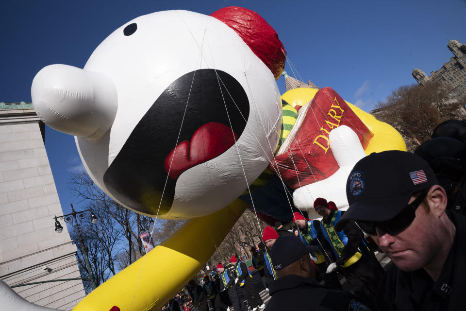 Balloon handlers hold Diary of a Wimpy Kid balloon close to the ground as strong winds affect the Macy's Thanksgiving Day Parade, Thursday, Nov. 28, 2019, in New York. (AP Photo/Mark Lennihan)