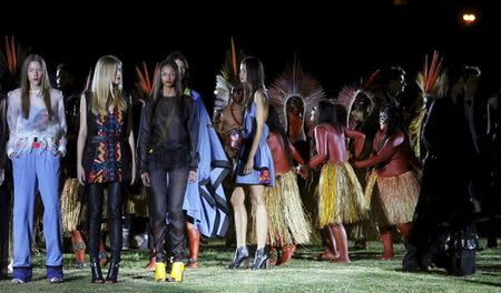 Models present creations from the Cavalera Summer 2016 Ready To Wear collection with indians of Yawanawa ethnicity during Sao Paulo Fashion Week in Sao Paulo April 13, 2015. REUTERS/Paulo Whitaker
