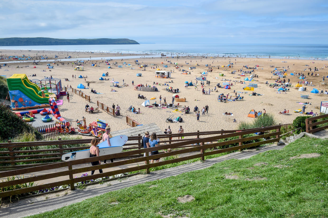 Surfers and sunseekers flock to the beach at Woolacombe, on the North Devonshire coast following the hottest August Bank Holiday Monday on record, with temperatures reaching 33.2C. The heatwave is set to continue for some parts of the UK after the record-breaking bank holiday weather. (Photo by Ben Birchall/PA Images via Getty Images)