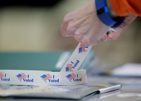 A voter peels off an "I Voted" sticker after voting in North Carolina's U.S. presidential primary election at Sharon Presbyterian Church in Charlotte, North Carolina, U.S. on March 15, 2016. REUTERS/Chris Keane/File Photo