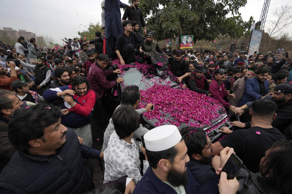 Security personnel clear way for a vehicle carrying former Pakistani Prime Minister Imran Khan after his court appearance, in Islamabad, Pakistan, Tuesday, Feb. 28, 2023. A Pakistani court approved bail for Khan after he appeared before a judge in Islamabad amid tight security, officials said, months after police filed terrorism charges against the country's popular opposition leader for inciting people to violence. (AP Photo/Anjum Naveed)