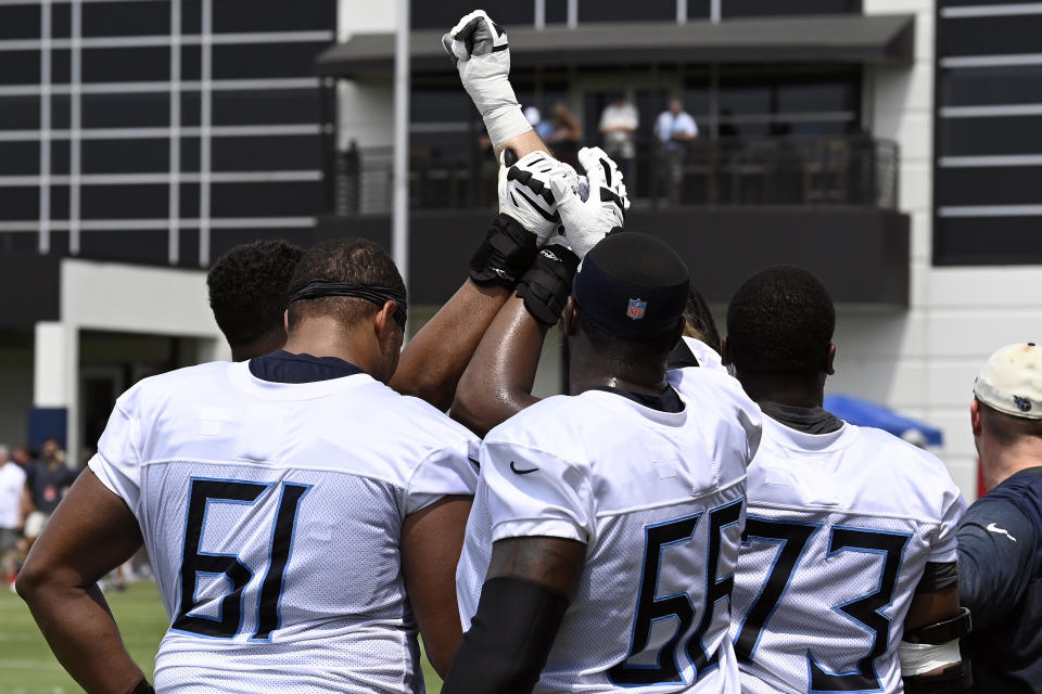 Tennessee Titans' John Ojukwu (61), Chris Hubbard (66), and Jamarco Jones (73) huddle after practice at NFL football training camp Saturday, July 29, 2023, in Nashville, Tenn. (AP Photo/Mark Zaleski)