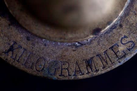 A one kilogram weight is seen in Saussay-la-Campagne, western France, November 15, 2018. REUTERS/Christian Hartmann