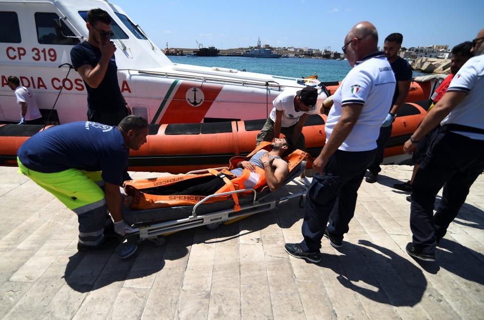 A migrant is carried on a stretcher, in Lampedusa, after those who jumped were brought to shore. (REUTERS)