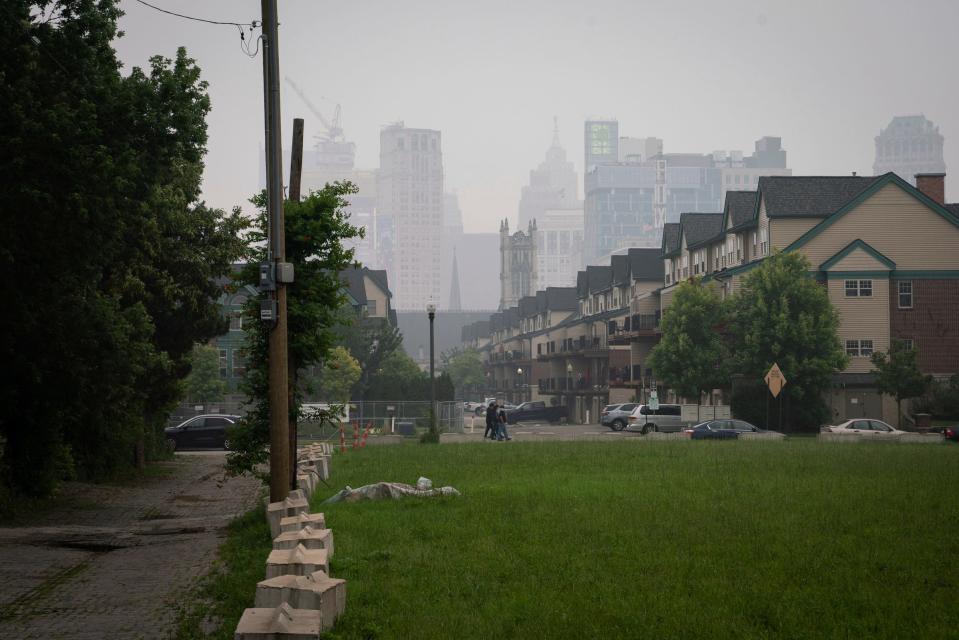 A downtown Detroit skyline is barely visible through haze and smoke, caused by the millions of acres burned by wildfires in Canada, in Detroit on Tuesday, June 27, 2023.