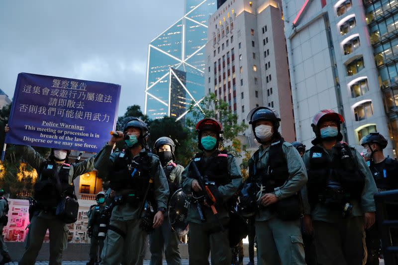 Riot police stand guard outside HSBC and Bank of China (Hong Kong ) headquarters during a protest to mark the first anniversary of a mass rally against a now-withdrawn extradition bill, in Hong Kong