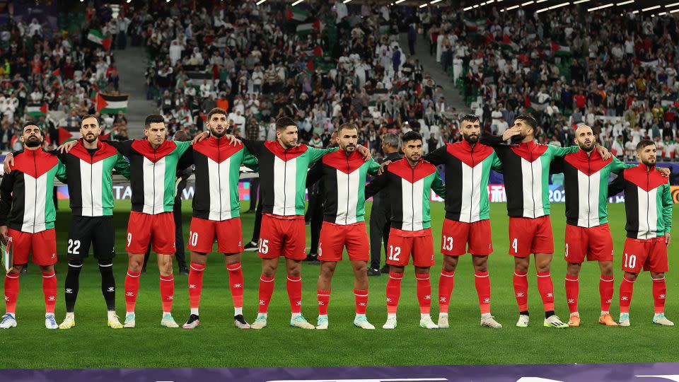 Palestinian national team players observe the national anthems prior to the AFC Asian Cup Group C match between Iran and Palestine at Education City Stadium on January 14, 2024 in Al Rayyan, Qatar. - Robert Cianflone/Getty Images