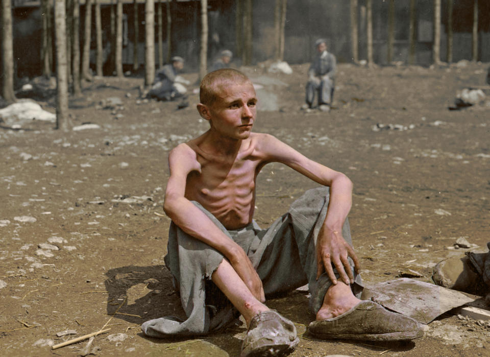 POLAND: Sadness and a skeletal frame - this was often all that was left of victims of the holocaust.  HARROWING colourised images of the Holocaust which expose the full terrors faced by the death camp?s inmates have emerged SEVENTY-FIVE-YEARS after the liberation of Auschwitz, the largest Nazi death camp. Sobering photos, some revamped in colour for the first time, capture the horror of genocide in the eyes of a gaunt 18-year-old Russian woman; a concentration camp responsible for the deaths of tens of thousands of innocent people being ceremonially burnt to the ground by liberating British forces; and malnourished Jewish children peering out at their Soviet rescuers through a barbed wire fence at Auschwitz. Other upsetting colourisations include a smiling portrait of four-year-old, Istvan Reiner, taken just a few weeks before he was murdered at the infamous death camp, and another showing a palpably relieved young Jewish refuge recuperating in hospital after being rescued by appalled Allied Forces. Mediadrumimages/TomMarshall(PhotograFix)2020