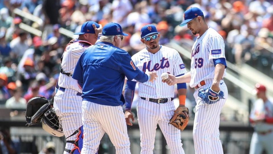 New York Mets starting pitcher Carlos Carrasco gives the ball to manager Buck Showalter after being taken out in the fourth inning against the St. Louis Cardinals at Citi Field.