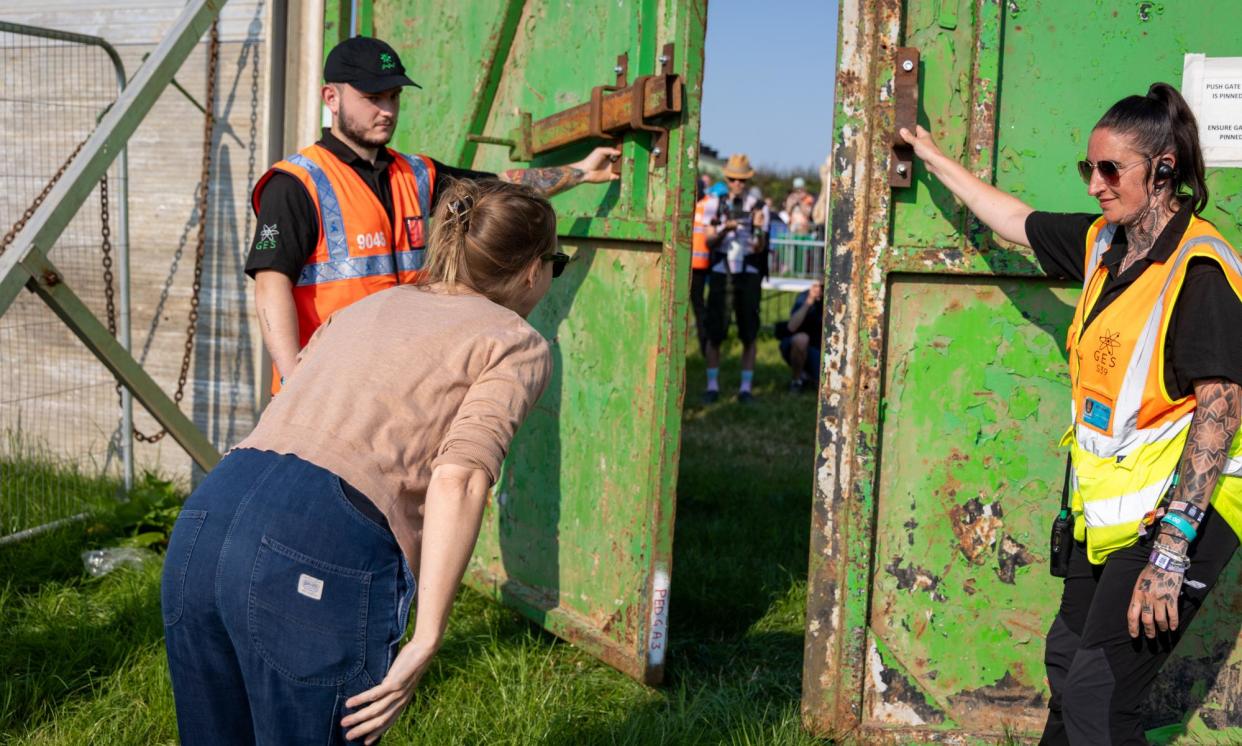 <span>Emily Eavis welcomes festivalgoers as she officially opens the pedestrian gate at Worthy Farm.</span><span>Photograph: Matt Cardy/Getty</span>