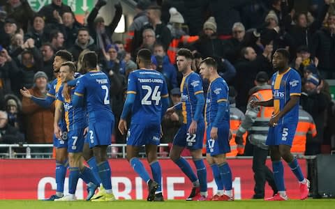 Shrewsbury Town's Shaun Whalley, second left, is congratulated by teammates after scoring a goal that was disallowed in a VAR decision during the English FA Cup Fourth Round replay soccer match between Liverpool and Shrewsbury Town - Credit: AP