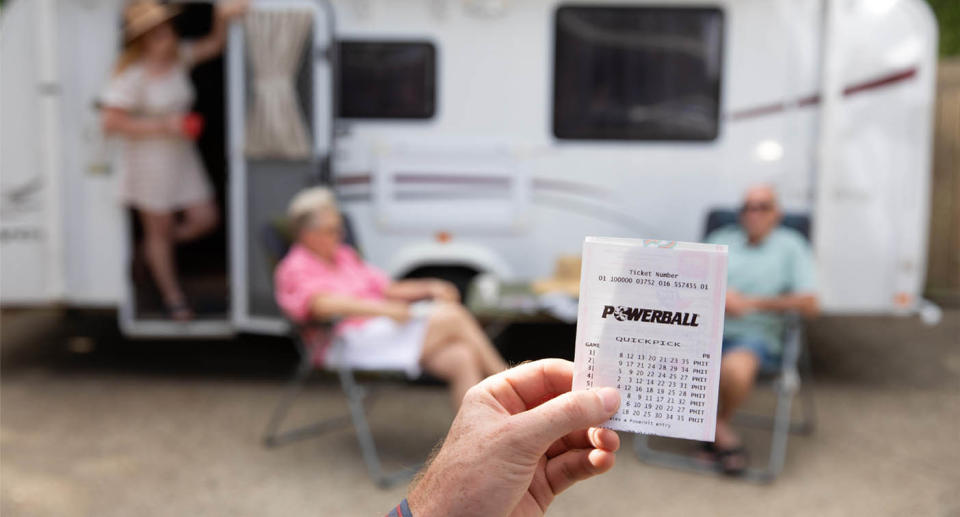 Older couple with caravan and Powerball ticket
