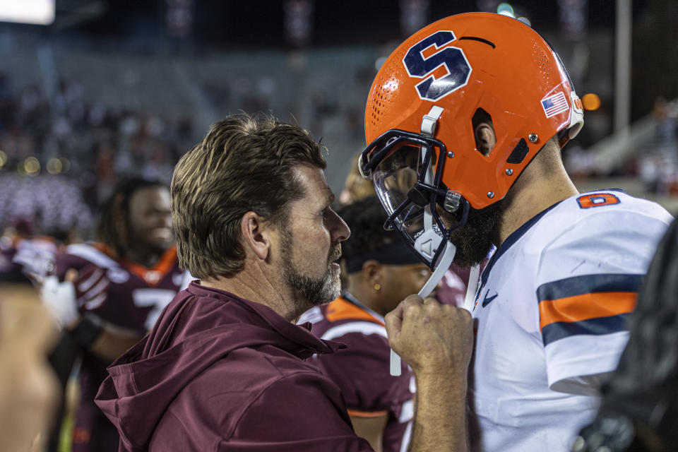 Virginia Tech coach Brent Pry meets Syracuse's Garrett Shrader an NCAA college football game Thursday, Oct. 26, 2023, in Blacksburg, Va. (AP Photo/Robert Simmons)