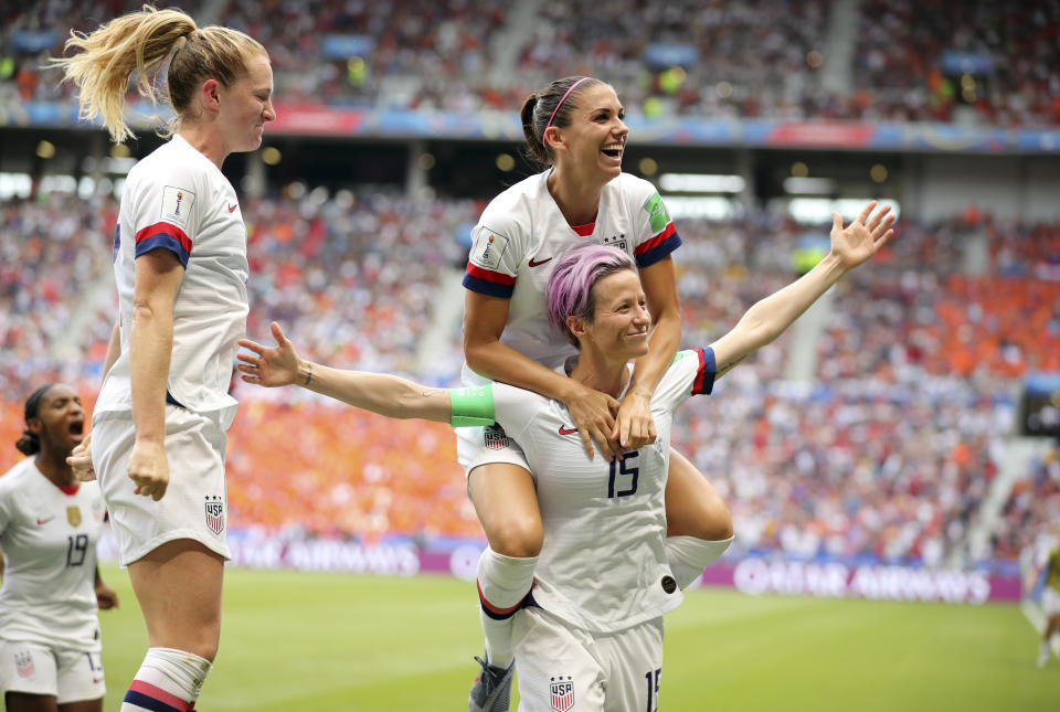 United States' Megan Rapinoe, right, celebrates after scoring the opening goal from the penalty spot during the Women's World Cup final soccer match between US and The Netherlands at the Stade de Lyon in Decines, outside Lyon, France, Sunday, July 7, 2019. (AP Photo/Francisco Seco)