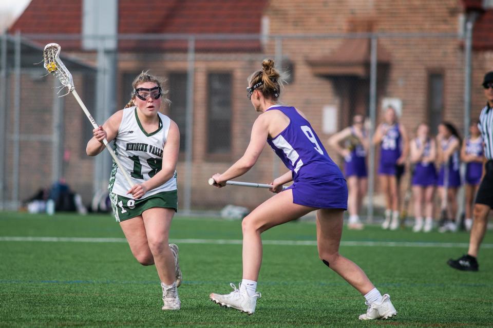 Minisink Valley's Molly Witkowski, left, flies by Warwick's Kaitlyn Larney during the Section 9 girls lacrosse game in Warwick, NY on Friday, April 8, 2022. Minisink Valley defeated Warwick. KELLY MARSH/FOR THE TIMES HERALD-RECORD