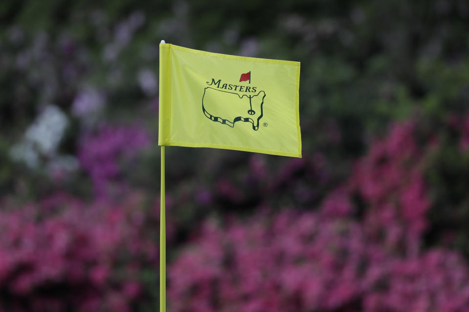 FILE - In this April 11, 2019, file photo, the flag on the 13th hole blows in the wind during the first round for the Masters golf tournament in Augusta, Ga. Augusta National decided Friday, March 13, 2020, to postpone the Masters because of the spread of the coronavirus. Club chairman Fred Ridley says he hopes postponing the event puts Augusta National in the best position to host the Masters and its other two events at some later date. Ridley did not say when it would be held.(AP Photo/David J. Phillip, Fil)