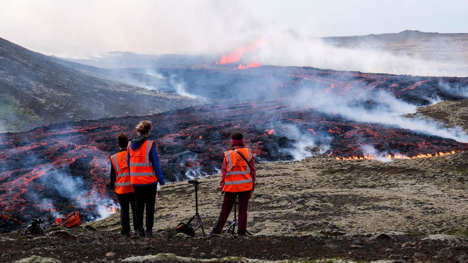 Observers from the University of Iceland watch a volcanic eruption near Litli Hrutur, Iceland on July 10, 2023. - Kristinn Magnusson/AFP/Getty Images