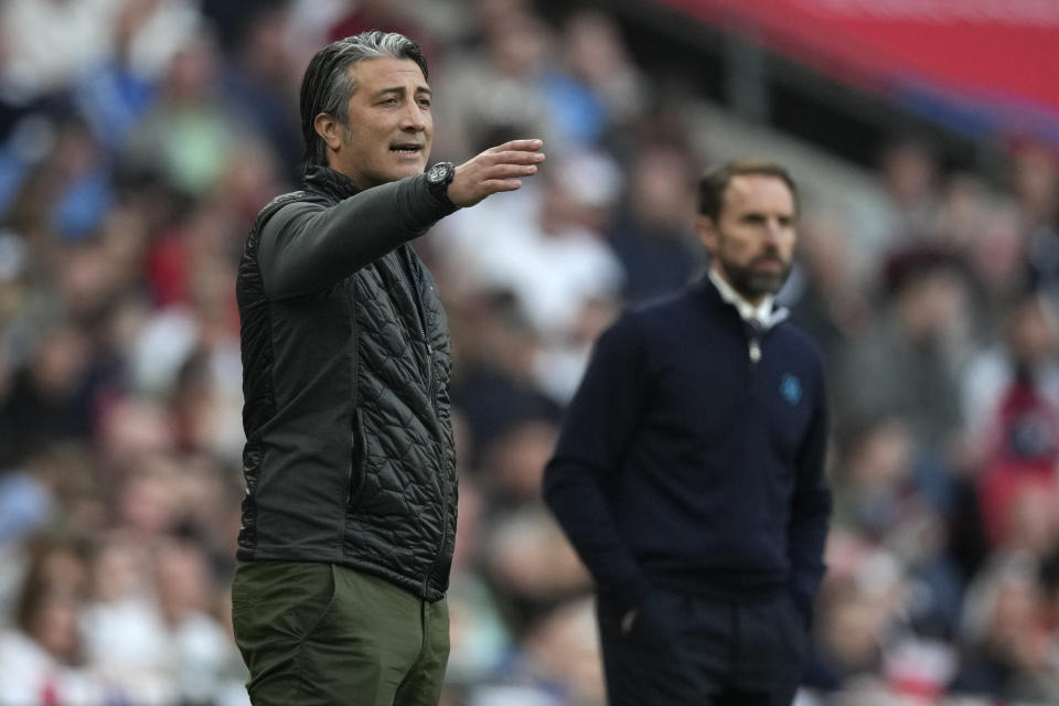 FILE - Switzerland coach Murat Yakin, left, gestures during an international soccer match between England and Switzerland at Wembley Stadium in London, Saturday, March 26, 2022. (AP Photo/Alastair Grant, File)