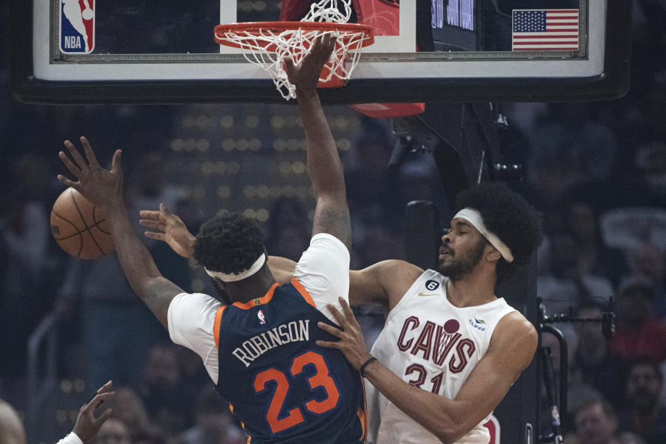 Cleveland Cavaliers' Jarrett Allen (31) and New York Knicks' Mitchell Robinson (23) vie for a rebound during the first half of Game 5 in an NBA basketball first-round playoff series Wednesday, April 26, 2023, in Cleveland. (AP Photo/Phil Long)