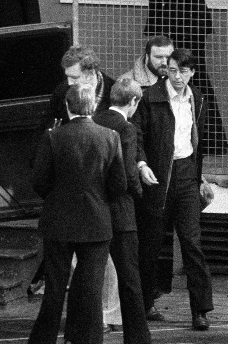 BLACK AND WHITE ONLY File photo dated 18/02/83 of Dennis Nilsen (right) leaving Highgate Magistrates Court where he was remanded in custody, charged with the murder of Stephen Sinclair in London. Serial killer Dennis Nilsen has died in prison, the Ministry of Justice has said.