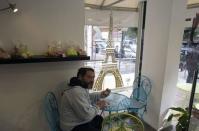 A member of the French community sits in a patisserie in Netanya, a city of 180,000 on the Mediterranean north of Tel Aviv, that has become the semi-official capital of the French community in Israel January 25, 2015. REUTERS/Ronen Zvulun