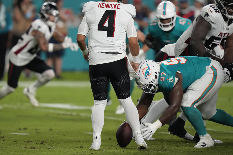 Miami Dolphins defensive tackle Isaiah Mack (97) recovers a fumble by Atlanta Falcons quarterback Taylor Heinicke (4) during the first half of a pre season NFL football game, Friday, Aug. 9, 2024, in Miami Gardens, Fla. (AP Photo/Lynne Sladky)