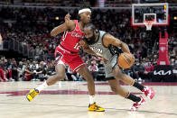 RETRANSMISSION TO REMOVE SCORE - Brooklyn Nets' James Harden, right, drives on Chicago Bulls' Ayo Dosunmu during the first half of an NBA basketball game Wednesday, Jan. 12, 2022, in Chicago. (AP Photo/Charles Rex Arbogast)