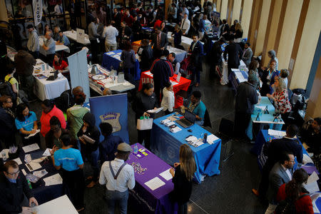 FILE PHOTO: Job seekers speak with potential employers at a City of Boston Neighborhood Career Fair on May Day in Boston, Massachusetts, U.S., May 1, 2017. REUTERS/Brian Snyder