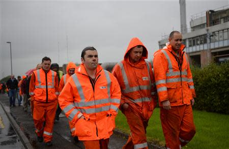 Workers leave a meeting where they learned that the decision to close the site, would be reversed, at the Grangemouth refinery in Scotland, October 25 2013. REUTERS/Russell Cheyne